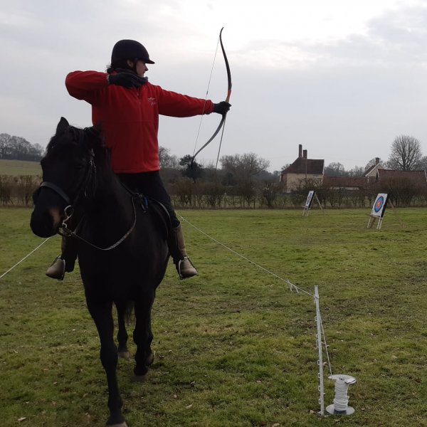 Horseback archer shooting arrow at target