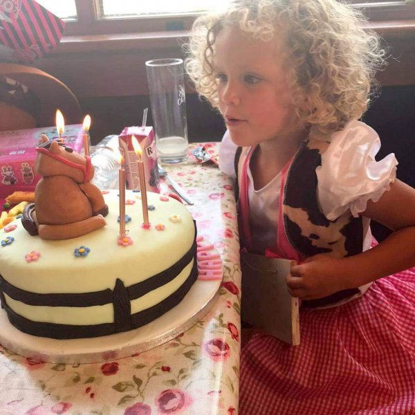 girl blowing out birthday candles