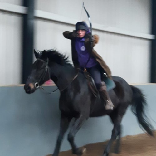 Archer on horseback cantering towards the camera